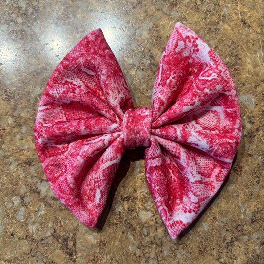 Pink snakeskin clip bow